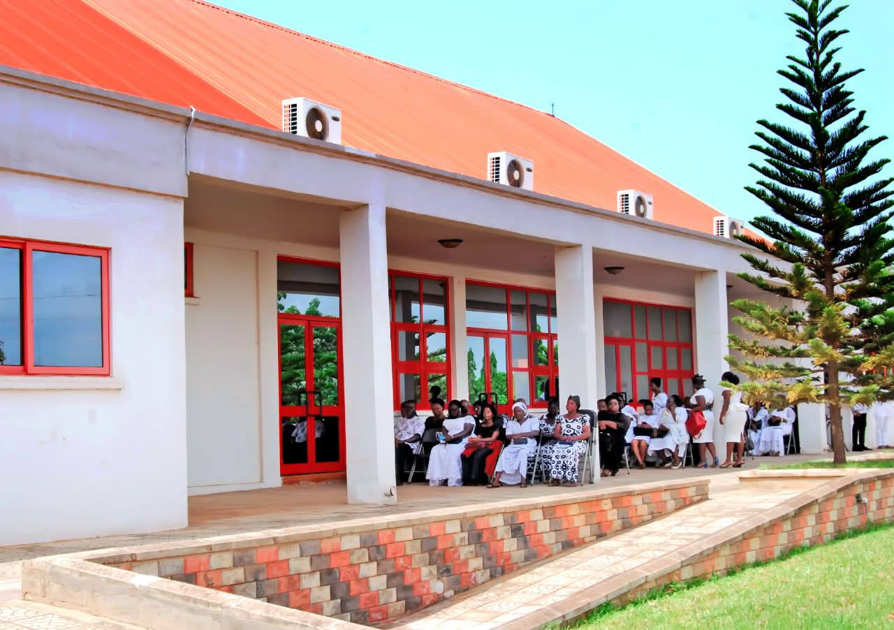 Covered walkways and shaded outdoor verandah at All Souls' Chapel accommodating mourners in a tranquil outdoor setting.